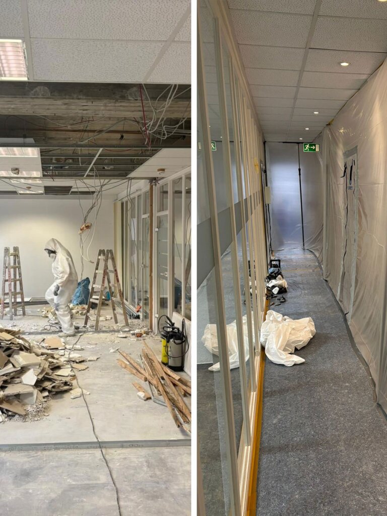 Person im weißen Schutzanzug schreitet durch Raum mit geöffnetem Deckensegment, freiliegenden Kabeln, Leitern und Bauschutt; rechts Korridor mit Plastikabdeckungen, Werkzeugen und Notausgangsschild.